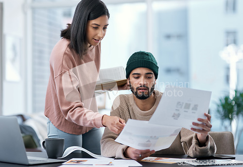 Image of Teamwork yields the highest return in any marriage. a young man and woman using a laptop and going though paperwork while working from home.