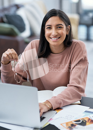 Image of Bringing you the best designs straight from my home. a confident young woman using a laptop while working from home.