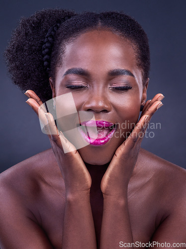 Image of Sparkle, shine and glow girl. Studio shot of a beautiful young woman posing against a black background.