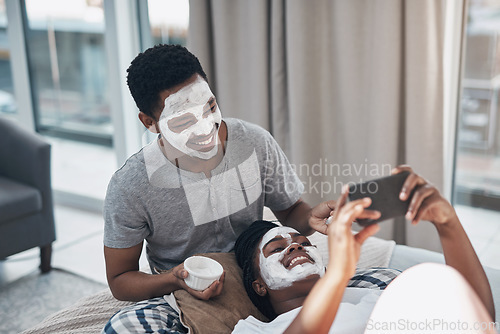 Image of Love and facials, the best ingredients to boost your glow. a young couple taking selfies while getting homemade facials together at home.