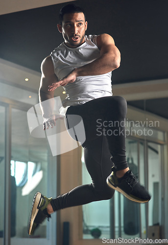 Image of Reaching new levels. Full length shot of a handsome young male athlete jumping during his workout in the gym.