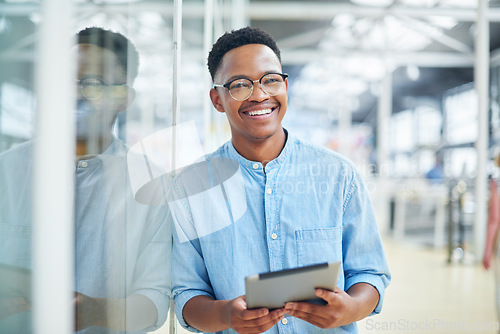 Image of To stay organised you’ve got too keep it smart. a young businessman using a digital tablet in a modern office.