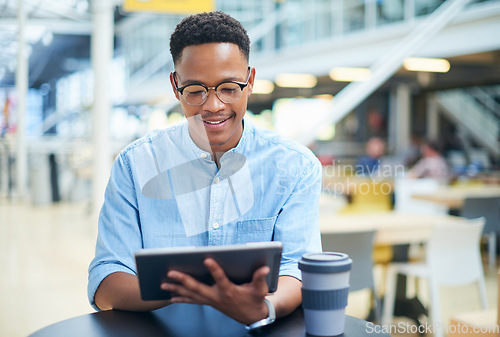 Image of A compact tool that keeps a work zone clutter free. a young businessman using a digital tablet during a coffee break in a modern office.