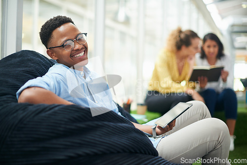 Image of No desk, no problem. a young businessman using a digital tablet in a modern office.