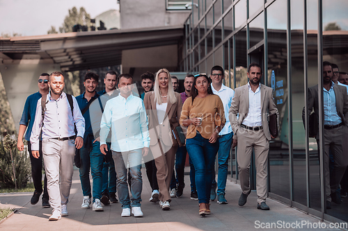 Image of A diverse group of businessmen and colleagues walking together by their workplace, showcasing collaboration and teamwork in the company.