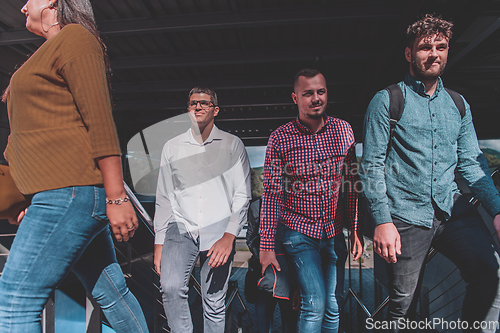 Image of A diverse group of businessmen and colleagues walking together by their workplace, showcasing collaboration and teamwork in the company.