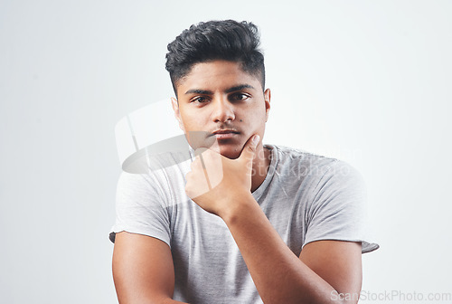 Image of Dont let it change you. Studio shot of a young man sitting against a white background.