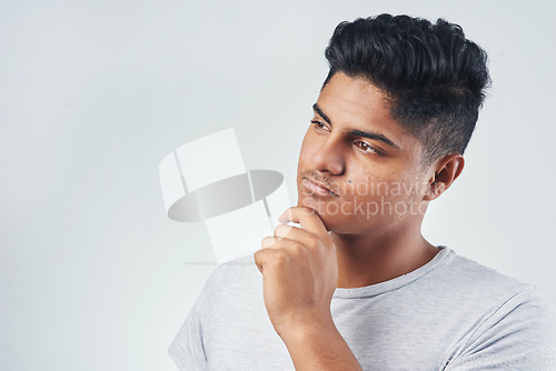 Image of I cant stop thinking about it. Studio shot of a young man posing against a white background.