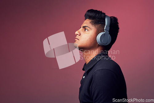 Image of Let music take control. Studio shot of a handsome young man wearing headphones.