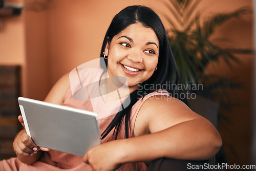 Image of Im sorted with my weekend entertainment. a young woman using a digital tablet at home.