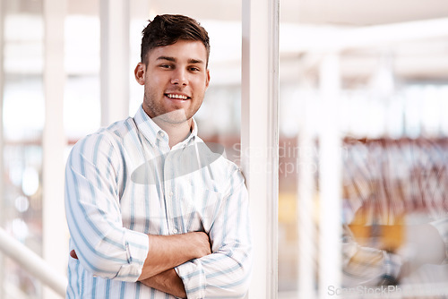 Image of Long-term success is the goal. Cropped portrait of a handsome young male designer standing with his arms folded in the office.