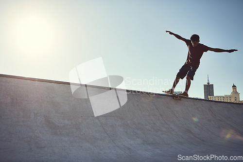 Image of Spread your wings and fly. Full length shot of a young man doing tricks on his skateboard at a skate park.