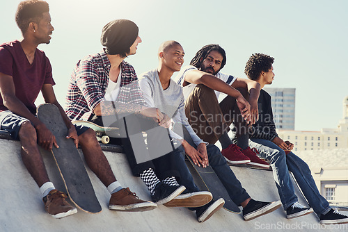 Image of Skating is our way of life. Full length shot of a group of young skaters sitting together on a ramp at a skatepark.