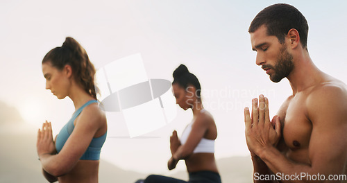 Image of We didnt choose the zen life, it chose us. a group of young people sitting and meditating together while on the beach during an overcast day.