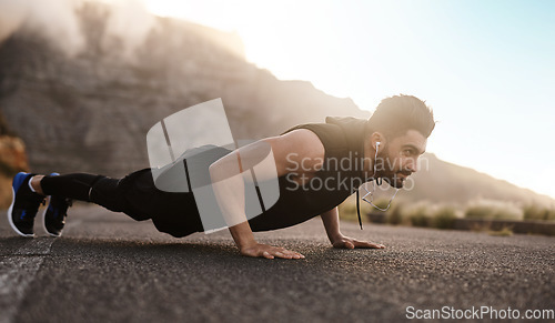 Image of You earn so much more when you dont give up. a sporty young man doing pushups while exercising outdoors.