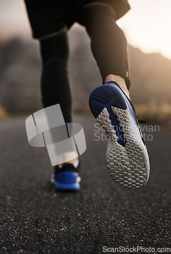 Image of Youll succeed as long as you keep going. Closeup shot of an unrecognizable man exercising outdoors.