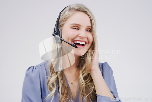 Image of She handles every call seamlessly and effortlessly. Studio shot of an attractive young female customer service representative wearing a headset against a grey background.