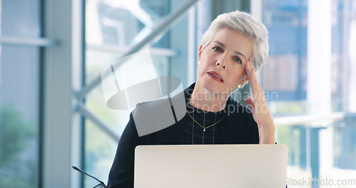 Image of Dealing with the downs of business. Portrait of a mature businesswoman looking stressed out while working in an office.