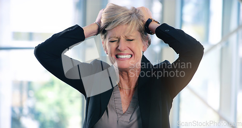 Image of Why wont anything go my way. a mature businesswoman looking stressed out in an office.