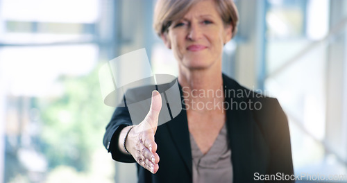 Image of Youre the one I want to do business with. Portrait of a mature businesswoman extending a handshake in an office.