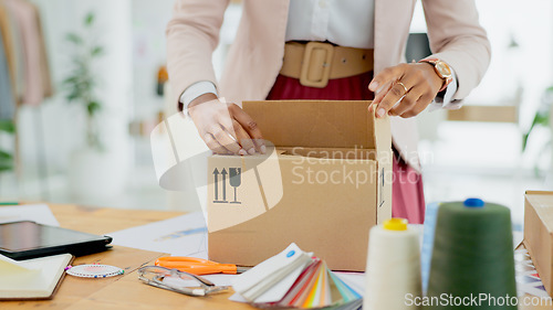 Image of Woman, hands and box of fashion designer in small business, supply chain or logistics at boutique store. Closeup of female person packing boxes for clothing, delivery or courier service at shop