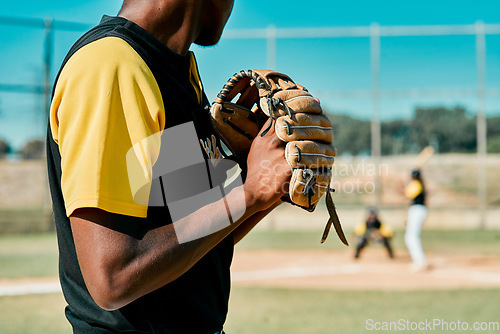 Image of This pitch will make or break him. a young baseball player getting ready to pitch the ball during a game outdoors.