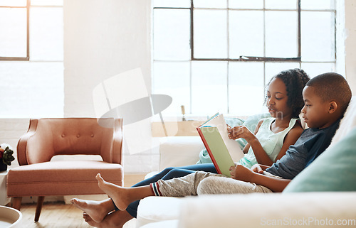 Image of We love the adventures reading takes us on. a little brother and sister reading a book indoors.