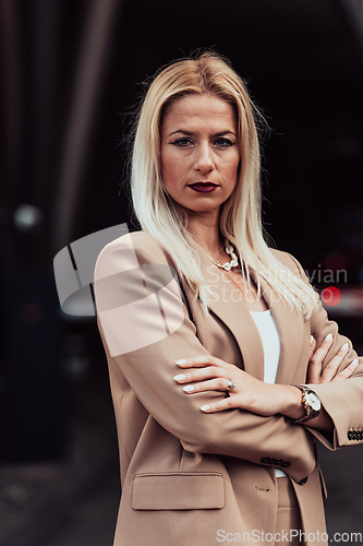 Image of A powerful portrait of a businesswoman, standing confidently with her arms crossed, representing the determination of the female gender and embodying strength and success