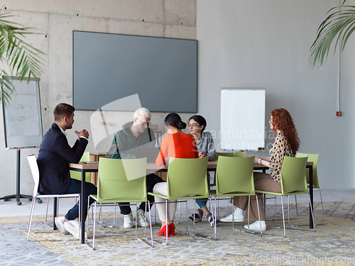 Image of A diverse group of business professionals gathered at a modern office for a productive and inclusive meeting