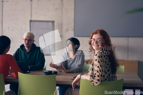 Image of A diverse group of business professionals gathered at a modern office for a productive and inclusive meeting