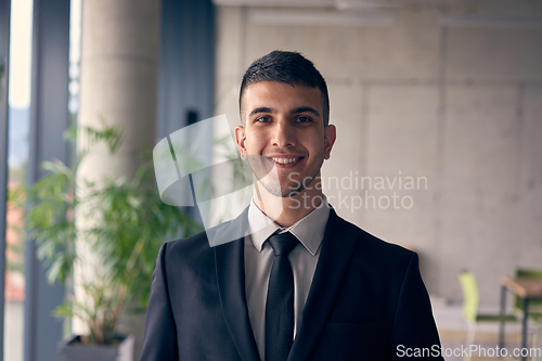 Image of A confident businessman with a briefcase strides through a modern office, exuding charisma and determination, symbolizing success and professional excellence.