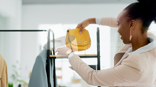 Image of Fashion, bag and a black woman designer in a retail store as a small business owner or startup entrepreneur. Smile, accessories and a happy young employee in a shop at the mall for boutique sales