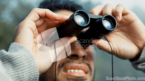 Image of Face, hiking and man with binocular in nature for sightseeing, explore or trekking a mountain environment. Travel, adventure and view with a young male hiker closeup outdoor in the woods or forest