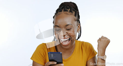 Image of Phone, black woman and happy fist for success, celebration or achievement and winner for giveaway in studio on white background. Excited, prize and person with smartphone celebrate winning lottery