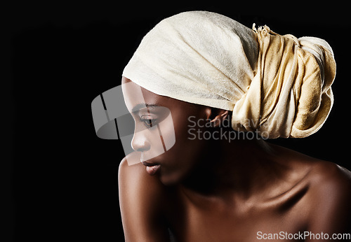 Image of Simplicity is the keynote of elegance. Studio shot of a beautiful woman wearing a headscarf against a black background.