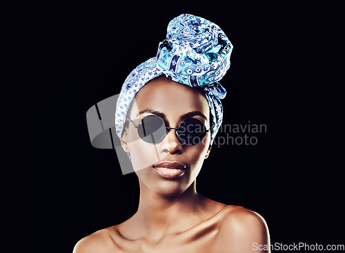 Image of In order to be irreplaceable, one must be different. Studio shot of a beautiful woman wearing a headscarf against a black background.