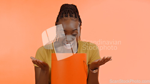 Image of Unboxing, present and black woman with birthday, surprise and box in studio background or celebration. Wow, congratulations and excited winner of giveaway, package and open box with happiness