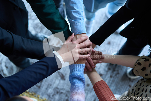 Image of A top view photo of group of businessmen holding hands together to symbolize unity and strength