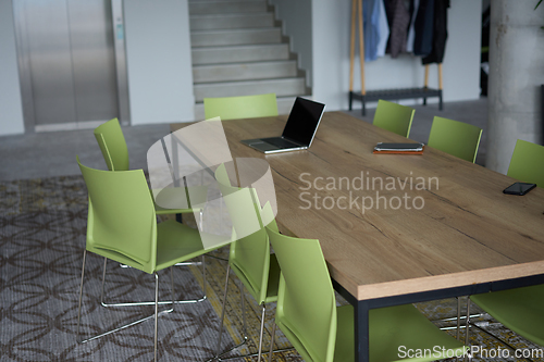 Image of Interior of a business facility showcasing a well equipped office with a laptop and smartphones, reflecting a modern and efficient work environment.