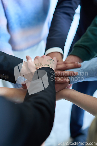 Image of A top view photo of group of businessmen holding hands together to symbolize unity and strength