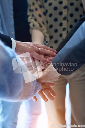 Image of A top view photo of group of businessmen holding hands together to symbolize unity and strength