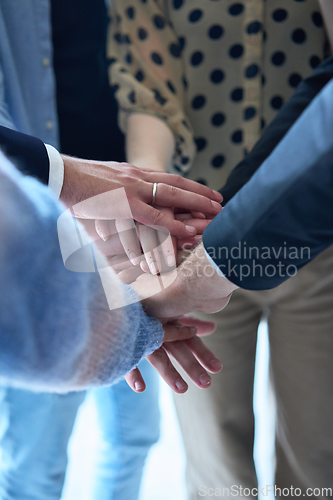 Image of A top view photo of group of businessmen holding hands together to symbolize unity and strength