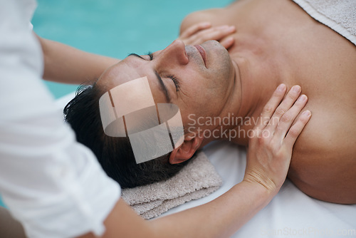 Image of Rubbing away the stress of a long week. a handsome man enjoying a massage at the spa.