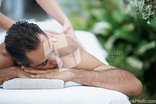 Image of Lost in a moment of relaxation. a handsome man enjoying a massage.