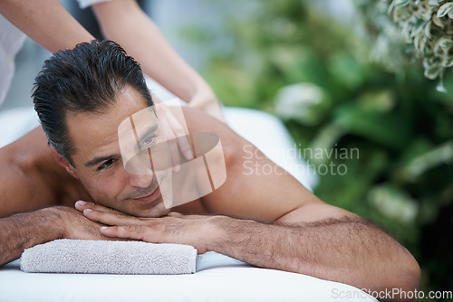 Image of He always come here to rid himself of stress. a handsome man enjoying a massage.