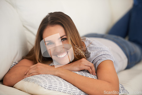 Image of The chill-out zone. a woman lying on her living room sofa.