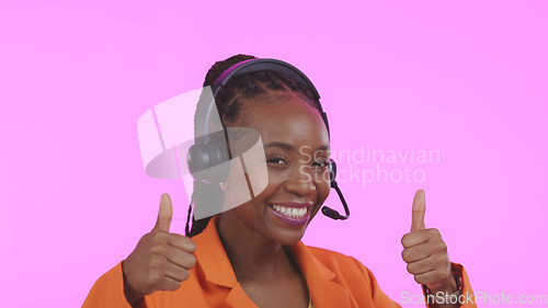 Image of Business woman, call center and thumbs up for communication, happy sales and customer service on pink background. Portrait of African consultant or agent, yes and like emoji for contact us in studio
