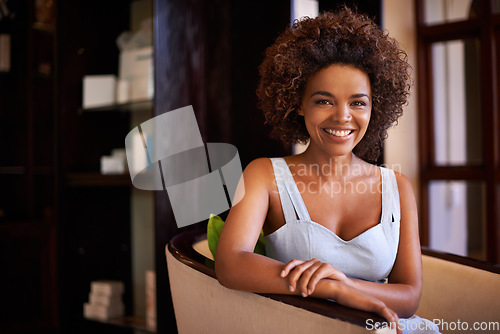 Image of Beaming smile and personality. a young woman sitting on a chair.