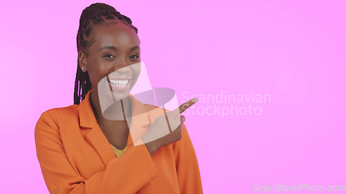 Image of Black woman, smile and pointing for advertising in studio on blank mock up space for presentation. Portrait, happy or person with promotion for business, marketing or offer on pink background