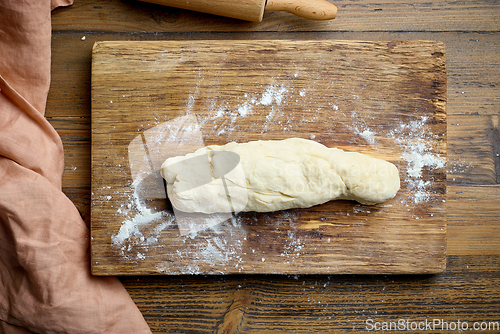 Image of dough on wooden cutting board